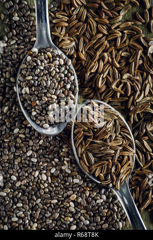 Spoons of cumin and chia seeds Stock Photo