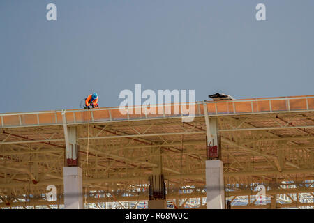 Construction workers on the roof of the building. Stock Photo