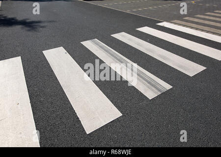 New painted crosswalk on black asphalt with nobody around. Stock Photo