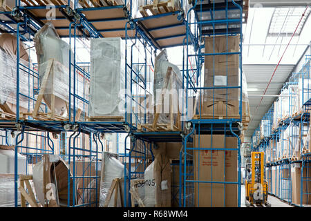 High-bay warehouses and yellow fork lifter. Stock Photo