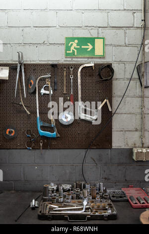 Wall with used tools in an old car workshop. Stock Photo