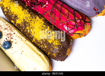 colorful eclairs background isolated on white, copy space Stock Photo