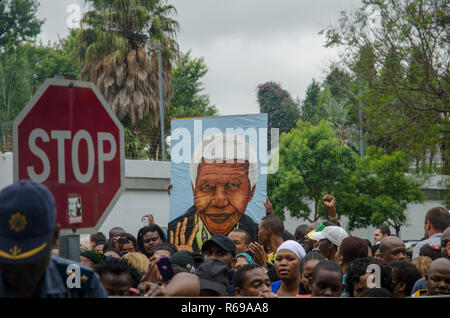 Mourners gather outside former President Nelson Mandela's house in Houghton, Johannesburg, Friday, December 6, 2013. The elder statesman died Thursday evening, December 5, 2013. PHOTO: EVA-LOTTA JANSSON Stock Photo