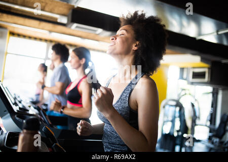 Happy gorup of healthy people training in gym Stock Photo