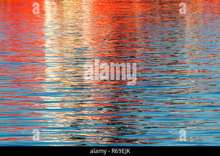 Reflections from a ship throwing interesting patterns on the water Stock Photo