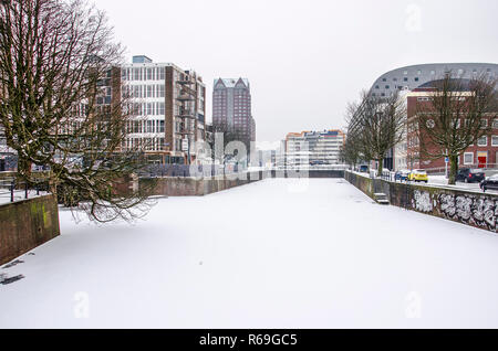 Rotterdam, March 3, 2018: view across frozen and snow-covered Steigersgracht canal towards Markthal and public library Stock Photo