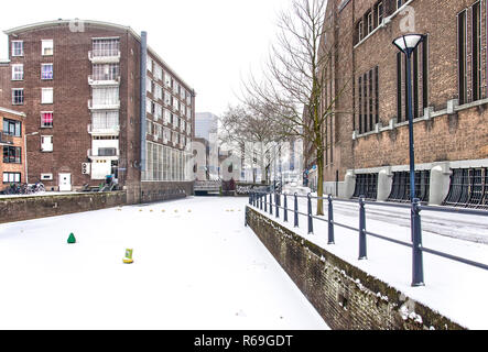 Rotterdam, March 3, 2018: frozen and snow-covered Delftsevaart canal in an almost deserted city center on a cold and grey day in winter Stock Photo