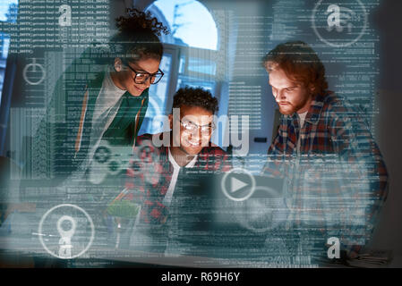 Young multinational game developers thinking of new project, team work Stock Photo