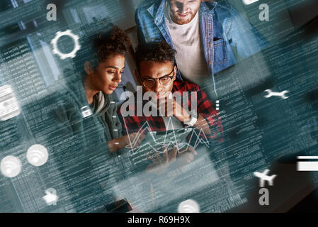 Young multinational code developers, team work of new navigation project Stock Photo