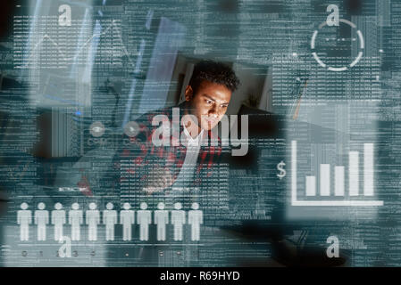 Young concentrated indian PPC specialist looking over advertising conversion Stock Photo