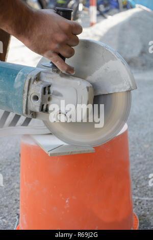 Skilled Worker Cuts Tiles With Angle Grinder Stock Photo
