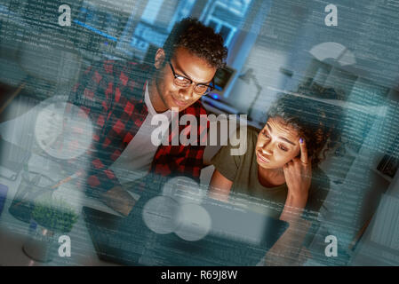 Young concentrated indian data analysts looking over the data Stock Photo