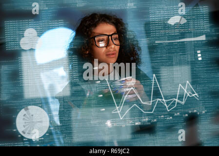 Young woman is thinking about the statistics Stock Photo