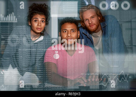 Young team of data analysts are looking over the data Stock Photo