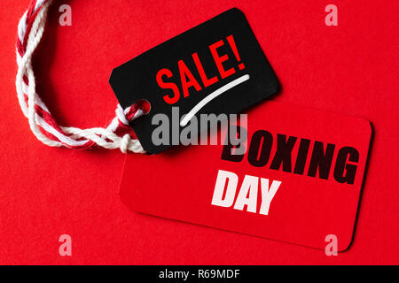 Boxing day Sale text on a red and black tag. Shopping concept. Stock Photo