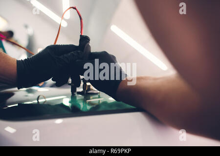 Using tools repairing to fix crack windshield Stock Photo