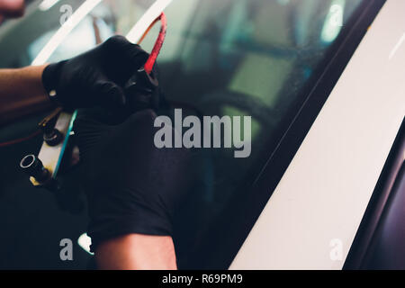Using tools repairing to fix crack windshield Stock Photo