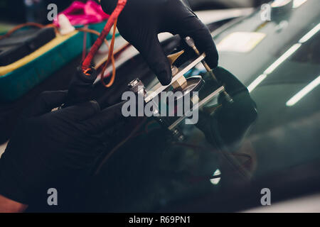 Using tools repairing to fix crack windshield Stock Photo