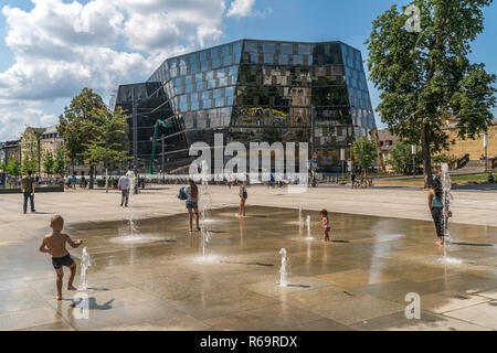 Playing children at the fountain in front of the university library Freiburg im Breisgau, Black Forest, Baden-Württemberg Stock Photo