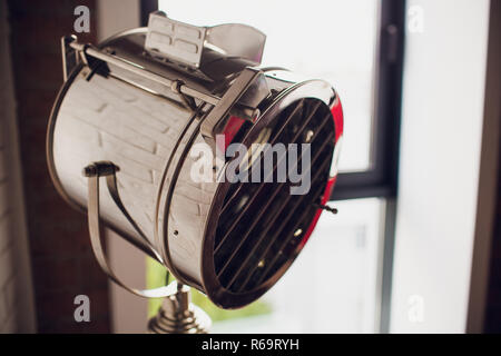 set retro spotlights on tripods in grunge wall background with copy space and text Stock Photo