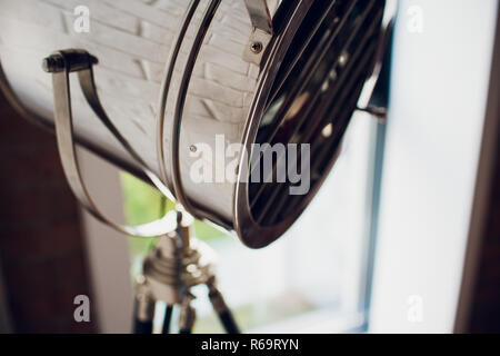 set retro spotlights on tripods in grunge wall background with copy space and text Stock Photo