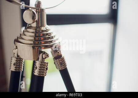 set retro spotlights on tripods in grunge wall background with copy space and text Stock Photo