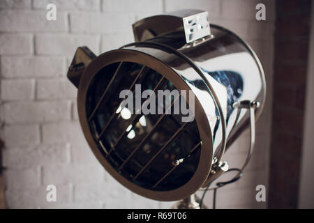 set retro spotlights on tripods in grunge wall background with copy space and text Stock Photo