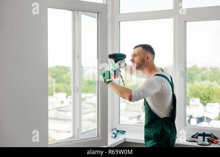 Man is doing window repair Stock Photo