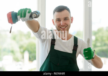 Handyman is showing thumb up Stock Photo