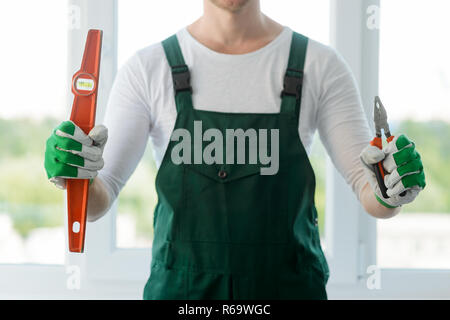 Builder tools in male hands Stock Photo