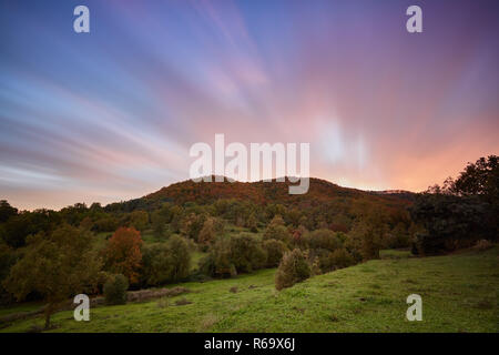 Nice long exposure picture, cloudscape over the mountain in sunset and autumn colors Stock Photo