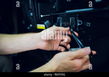 Mechanic installing car central door lock motor. Stock Photo