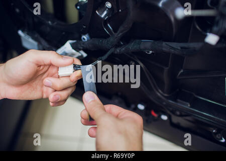 Mechanic installing car central door lock motor. Stock Photo