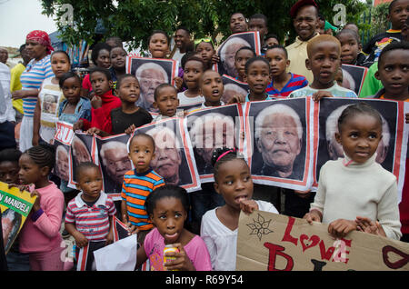 Children holding pictures of former President Nelson Mandela in Vilakazi Street, Soweto, Friday, December 6, 2013. The elder statesman died Thursday evening, December 5, 2013. PHOTO: EVA-LOTTA JANSSON Stock Photo