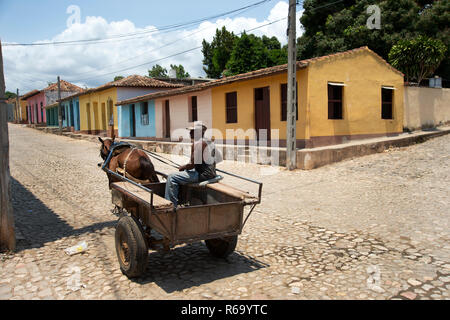 A dilapidated horse and cart taxi on the deserted cobbled streets of Trinidad Cuba Stock Photo