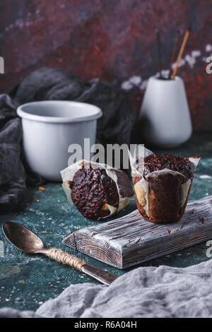 Homemade Carrot-chocolate muffin with a cup of tea on a dark table Close up Stock Photo