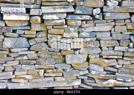Stone wall built with blocks and marble slabs simply placed over one another Stock Photo