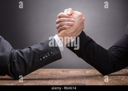 Two Businesspeople Competing In Arm Wrestling Stock Photo