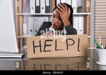 Upset Woman Holding Cardboard With Help Text Stock Photo