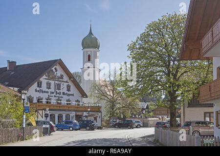 Church Of St. Martin And The Pub Post In Egling A Small Village In Upper Bavaria Stock Photo