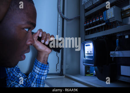 Electrician Examining A Electric Meter Stock Photo