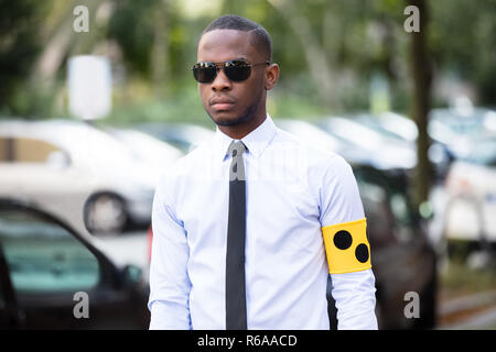 Blind Man Wearing Yellow Arm Band And Sunglasses Stock Photo