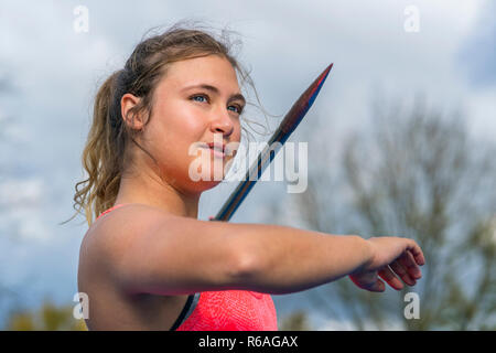 young woman javelin throwing in athletics Stock Photo