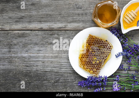 Honey with lavender flowers and honeycombs on rustic wooden table. healthy food. top view with copy space Stock Photo