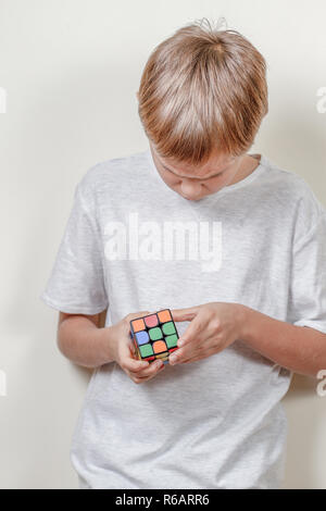 Xiaomi GiiKER Magnetic Magic Cube toy in kid hands. Xiaomi is Chinese electronics company. Stock Photo