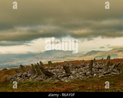 Bryn Cader Faner Cairn Circle. A combination of burial mound with a stone circle of slabs. Set in a scenic landscape with mount Snowdon to the north. Stock Photo