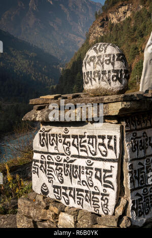 Nepal, Nurning, round Buddhist mani stone on top of mani wall on Everest Base Camp Trek path Stock Photo