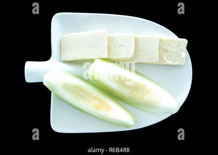 Feta cheese and melon plate for Turkish raki table on black background Stock Photo