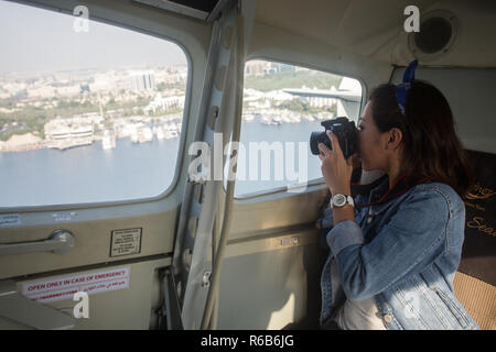 A female Asian model prepares for a Seaplane Flight in Dubai, United Arab Emirates. Stock Photo
