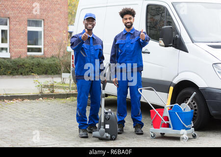 Portrait Of Two Happy Male Janitor Stock Photo